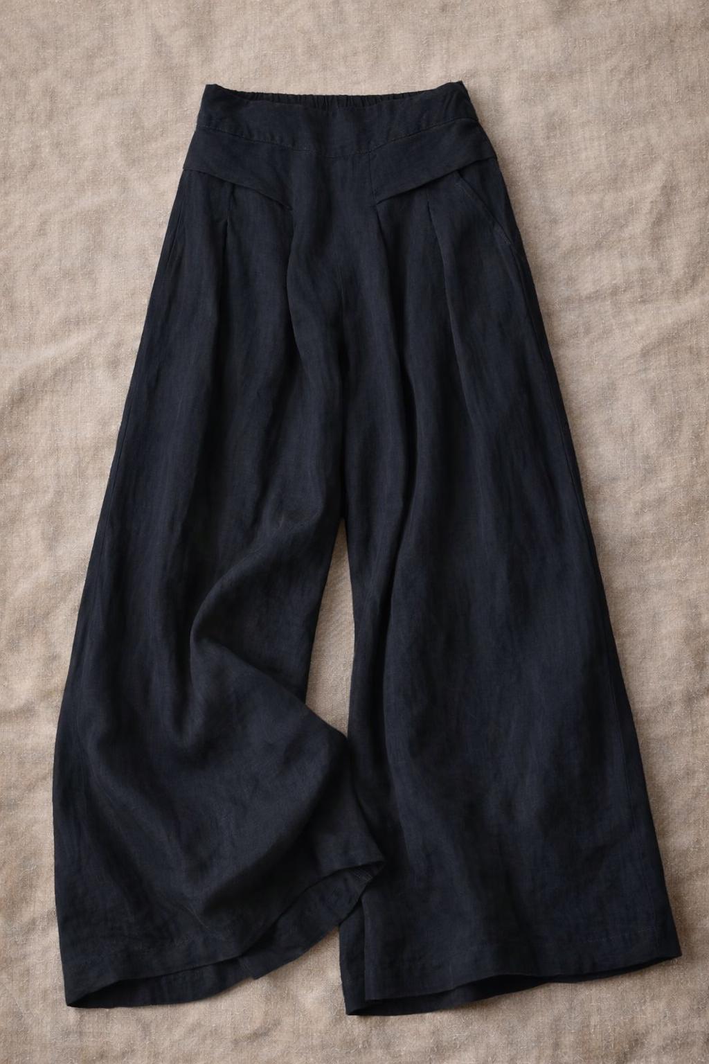 Pantalones de pierna ancha, cintura elástica con bolsillos, estilo elegante e informal.